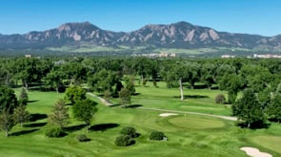 Aerial view of Flatirons Golf Course with the iconic Boulder Flatirons
